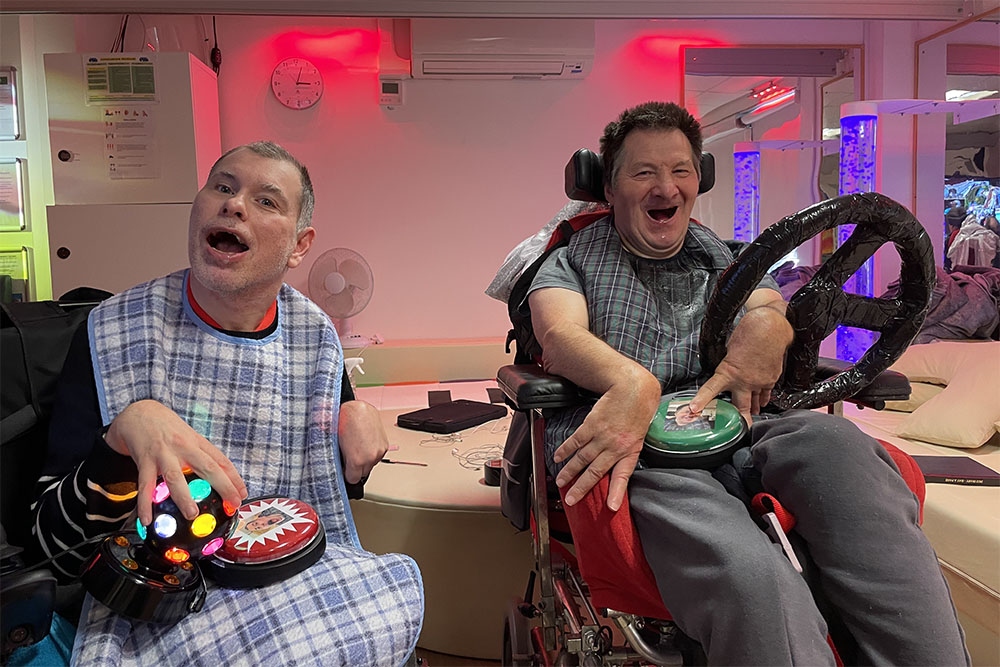 two men with assistive tech