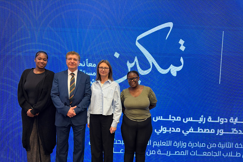 group of people in front of conference banner