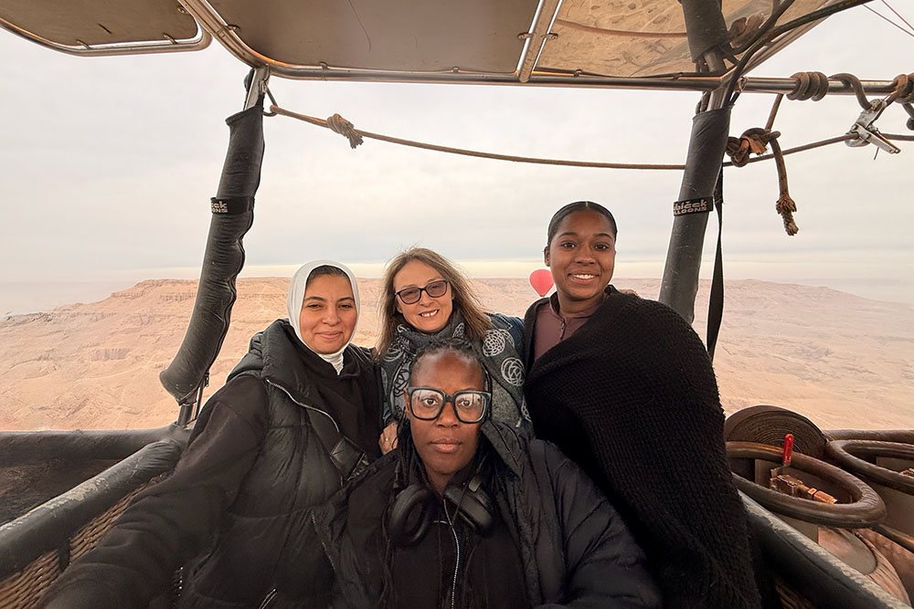 four people in a hot air balloon
