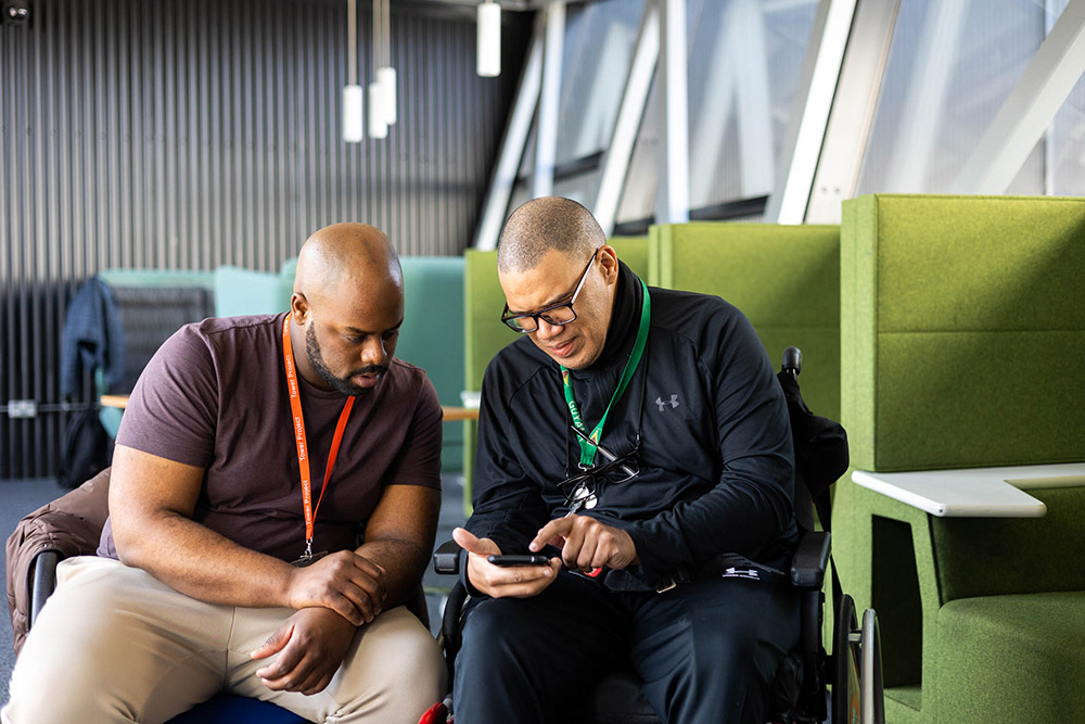 two men looking at a screen