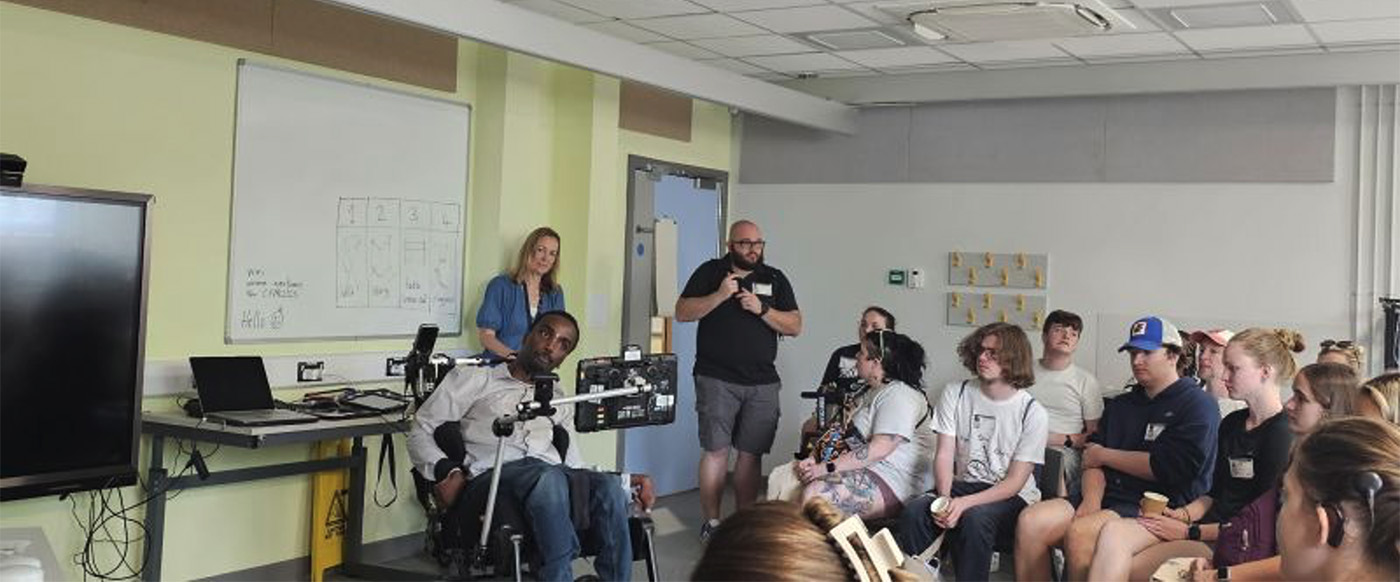 man in wheelchair presents to students